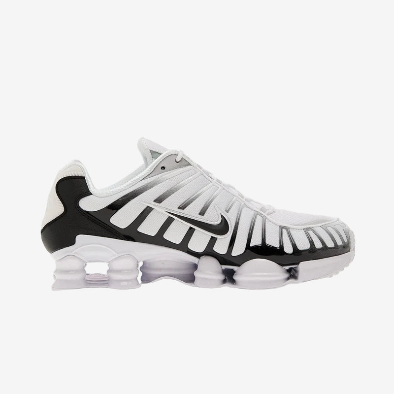 Nike Shox TL White/Black-Metallic Platinum athletic shoes with breathable mesh and TPU overlays for support.