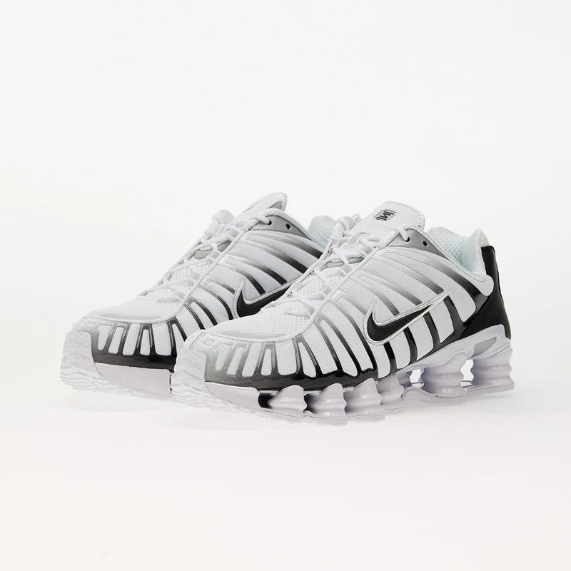 Nike Shox TL White/Black-Metallic Platinum sneakers with breathable mesh and TPU overlays for support.