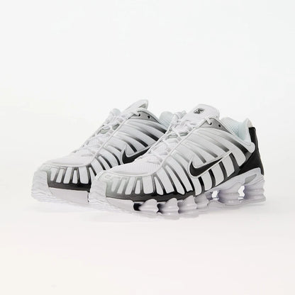 Nike Shox TL White/Black-Metallic Platinum sneakers with breathable mesh and TPU overlays for support.